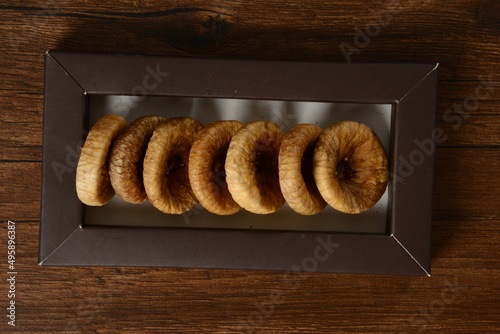 Fresh almonds in the wooden bowl, Organic almonds, almonds border white background, Almond nuts on a dark wooden background. Healthy snacks. Top view. Free space for text. photo