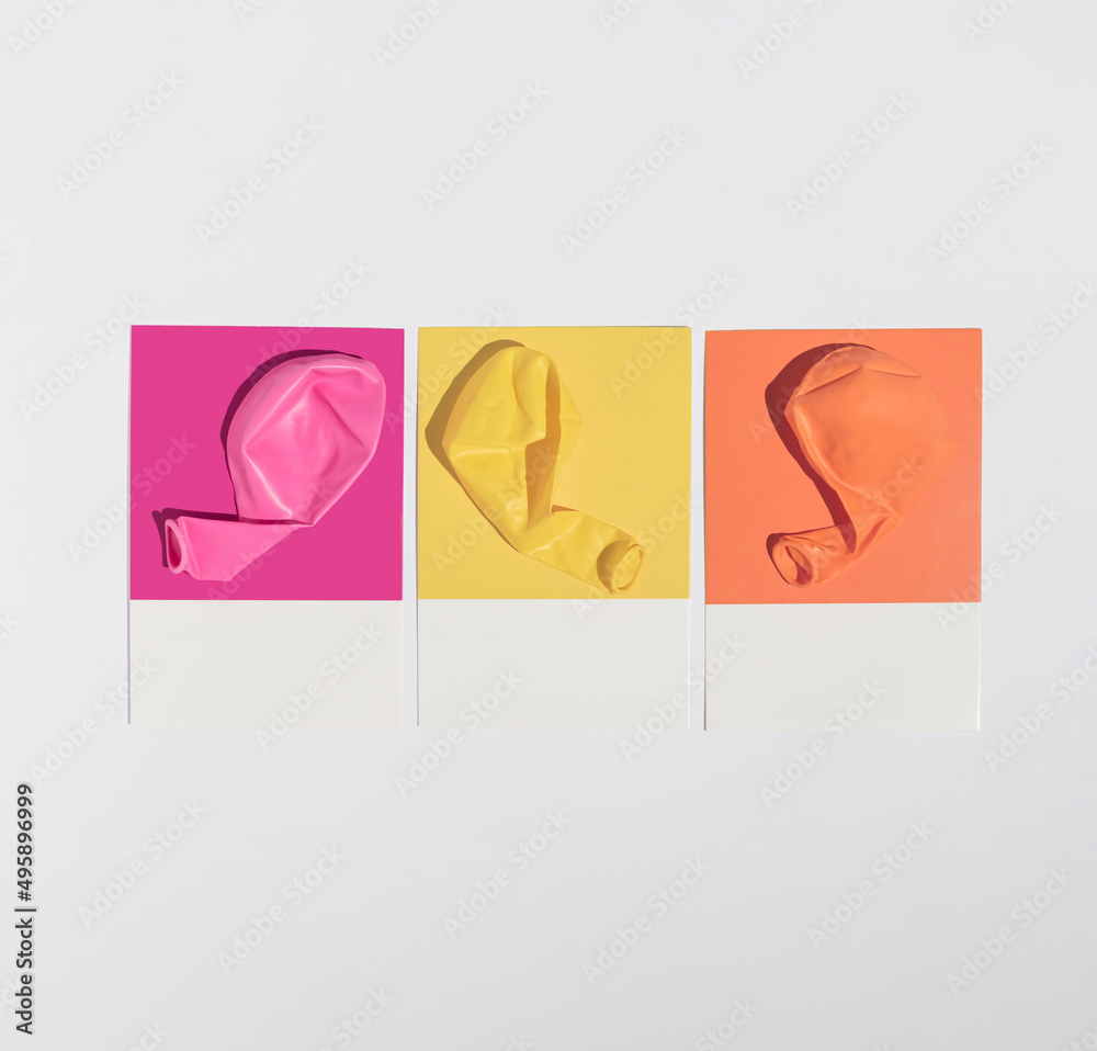 Obraz premium Minimal colorful vibrant party concept with three pink, yellow and orange birthday balloons. Modern summer aesthetic.