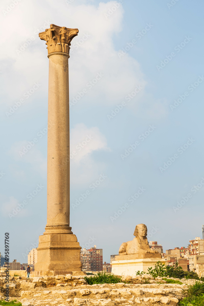 Pompey's pillar and ancient sphinx statue roman triumphal column in Alexandria, Egypt