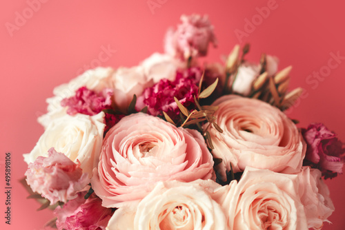 Bright pink flowers bouquet closeup. Roses and orchids wallpaper. Beautiful background for a Birthday, International Female Day, or Saint Valentine. The festive backdrop for a postcard design