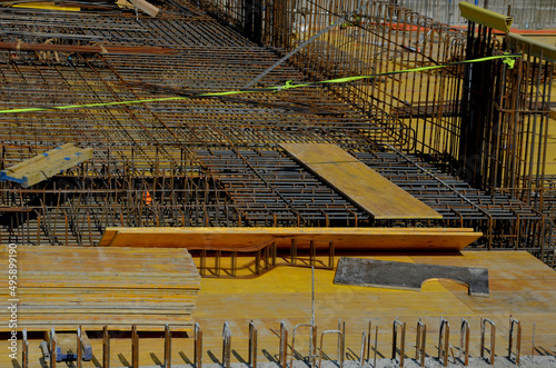 houses built of reinforced steel concrete are earthquake resistant and can be several stories high. wire mesh is braided and poured with concrete from the mixer 