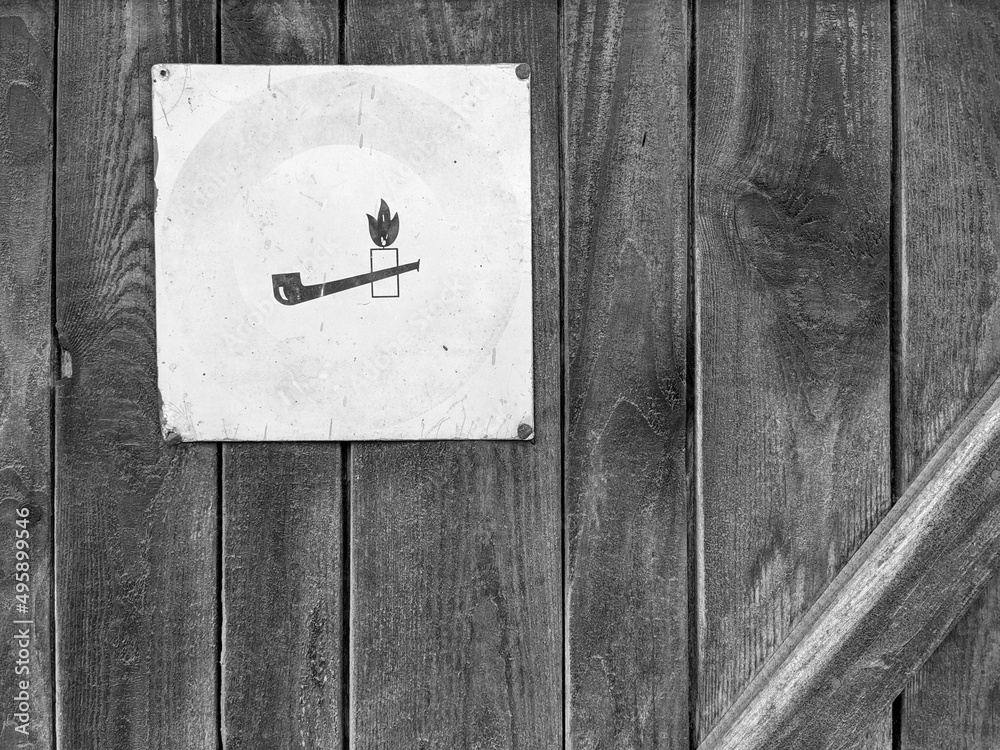 Old wooden door with warning sign