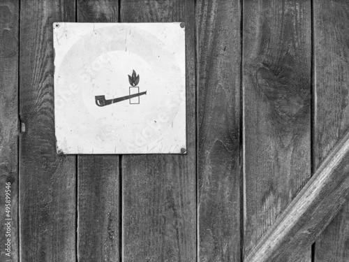 Old wooden door with warning sign