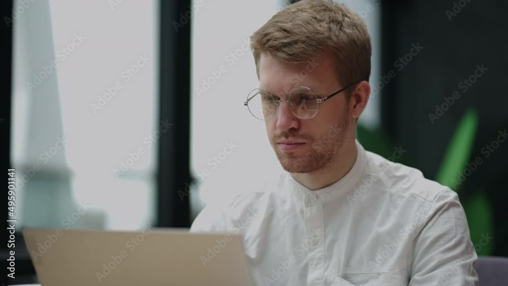male programmer is working in office or in home, portrait of man with laptop, sending emails