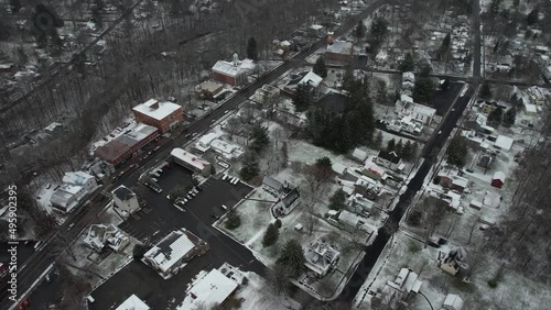 Aerial View of Winter Season in Small American Town, Snow Capped Buildings and Icy Streets. Trumansburg NY USA - Drone Shot photo