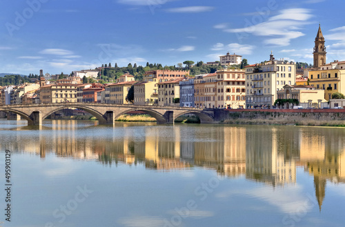 view of the city of florence in Italy from river Arno with reflection of colorful buildings on the water