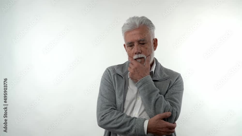 Portrait of an elderly caucasian stylish man in a sad depressed state posing in the studio on a white background. Concept of trend aging. Portrait of an elderly caucasian stylish man in a sad depressed state posing in the studio on a white background. Concept of trend aging.