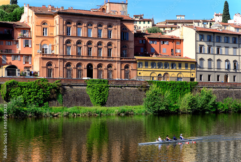 Sport activity on Arno river, facades of historic residential buildings along Lungarno Torrigiani street, Florence, Tuscany, Italy, Europe