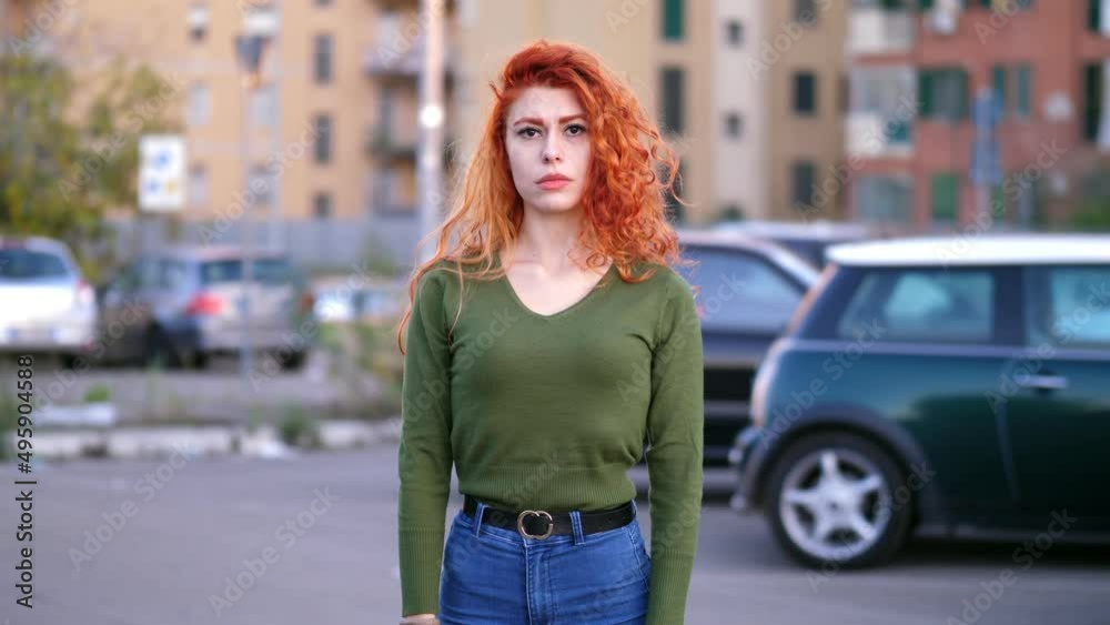 young woman distressed by a problem that torments her looks at the camera sighing young woman distressed by a problem that torments her looks at the camera sighing