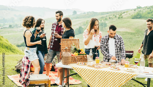 Tableau sur toile Happy young friends having fun doing barbecue party at vineyard outdoor - Focus