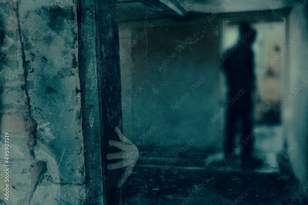 A haunted concept of a spooky ghost figure standing in a ruined house. With a grunge, old edit