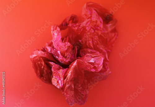 Crumpled red package on a red background