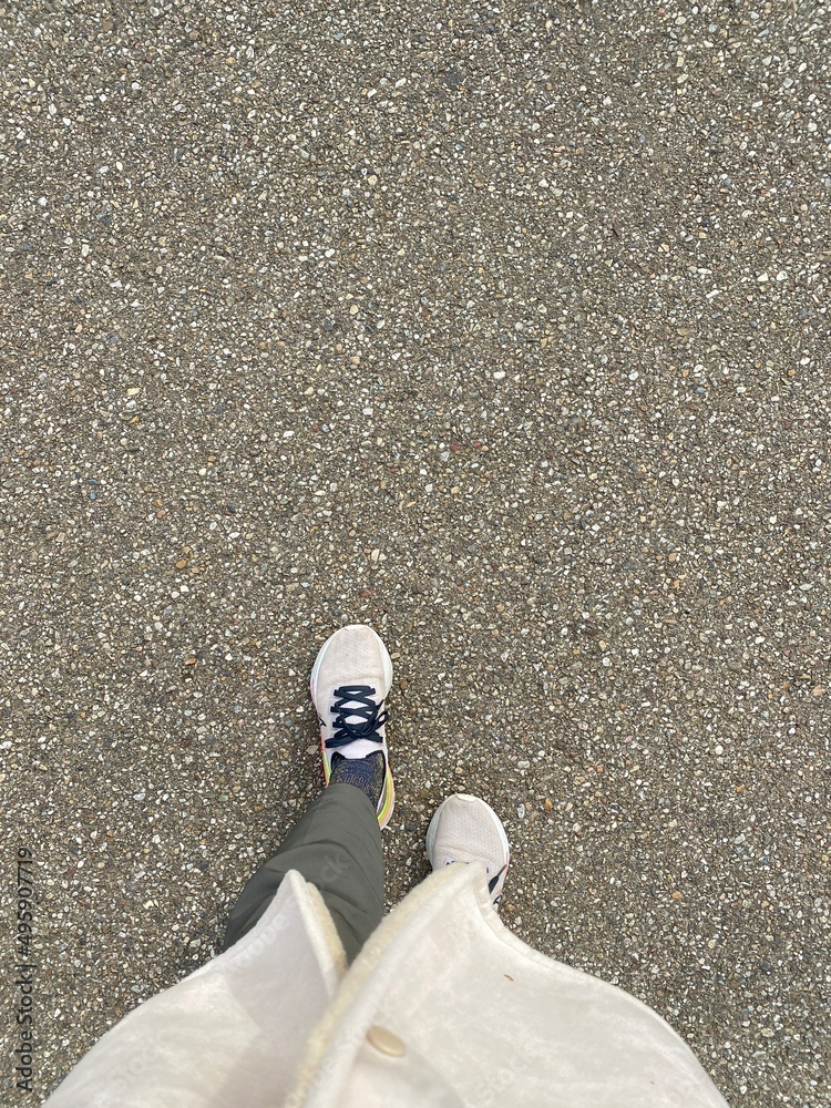 Obraz premium The walking sneaker on the concrete pavement