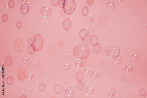Soap bubble pattern in front of the pink background.