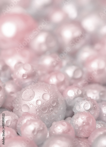 Beautiful background pink pearl pearls, top view. Abstract texture for festive backgrounds. Shiny surface of Christmas decorations. Gems close-up. Multicolored bright background.