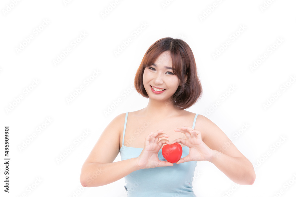 Young woman is holding a red heart for international cardiology day, love, charity, health insurance concept. Young woman is holding a red heart for international cardiology day, love, charity, health insurance concept.