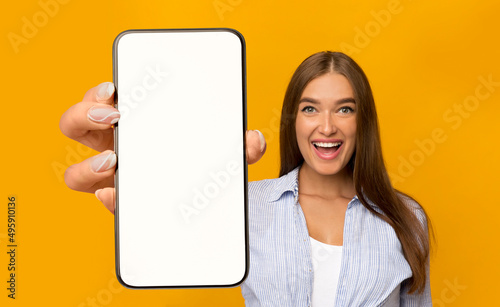 Excited Beautiful Lady Holding Big Blank Cellphone With White Screen In Hand © Prostock-studio