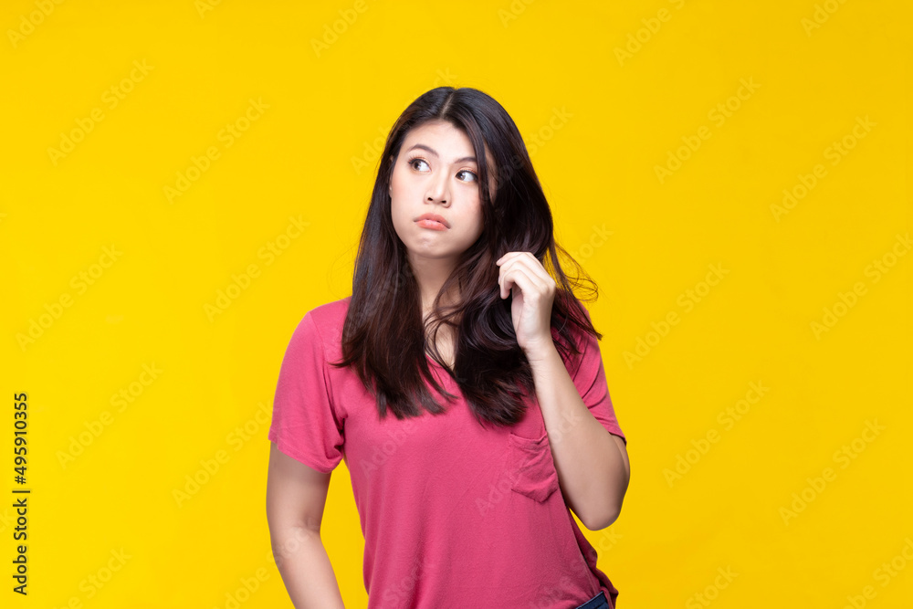 Image of feeling excited, shock, surprise and happy. Young asian woman standing on yellow background. Female face expressions and emotions body language concept. Image of feeling excited, shock, surprise and happy. Young asian woman standing on yellow background. Female face expressions and emotions body language concept.