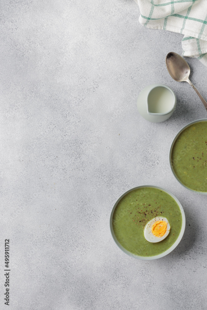 Spinach cream soup with boiled egg top view Spinach cream soup with boiled egg top view