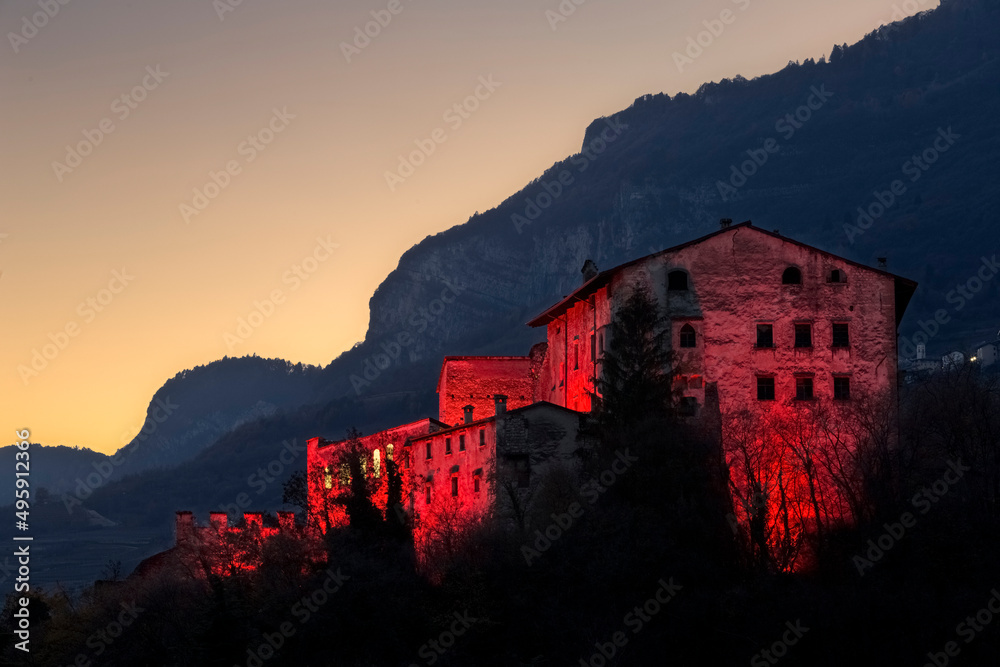 Twilight over the Noarna castle. In the 17th century it was the scene of a famous witch trial. Nogaredo, Trento province, Trentino Alto-Adige, Italy, Europe. Twilight over the Noarna castle. In the 17th century it was the scene of a famous witch trial. Nogaredo, Trento province, Trentino Alto-Adige, Italy, Europe.