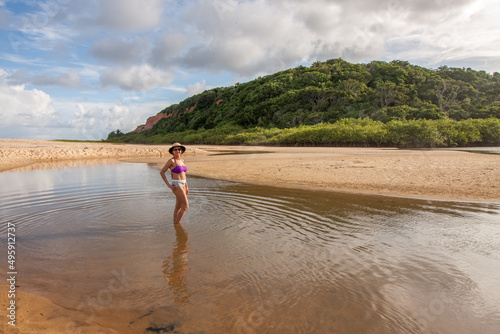 Lady standing at the beach known as Taipe near Arraial d’ Ajuda, Biaha, Brazil photo