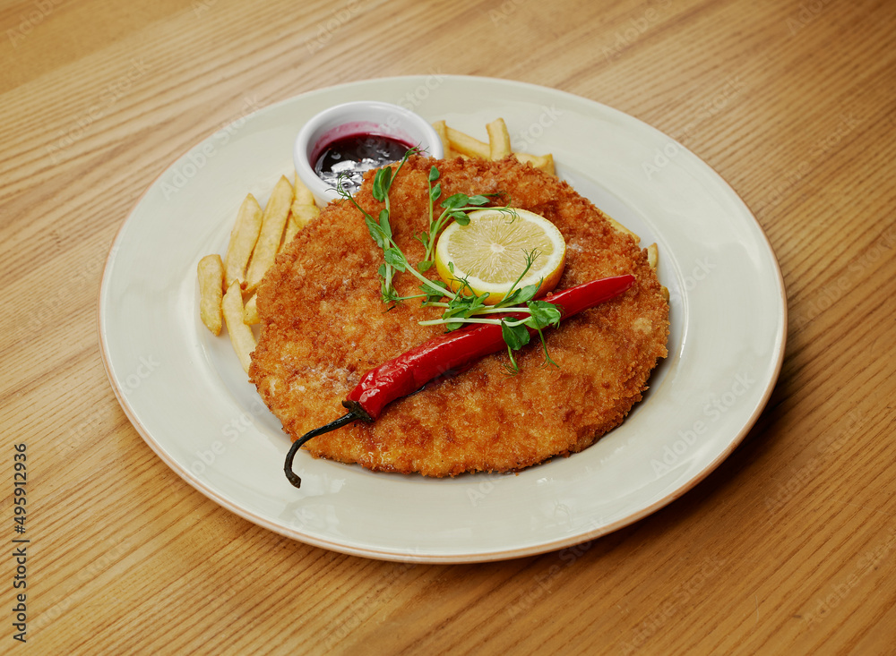 schnitzel with french fries, sauce and pepper schnitzel with french fries, sauce and pepper