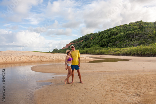 Mature couple standing at the beach known as Taipe near Arraial d’ Ajuda, Biaha, Brazil photo