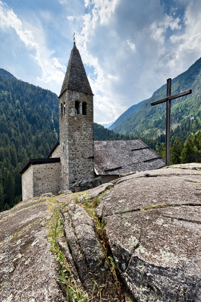 The medieval Santo Stefano church stands on a rocky spur at the entrance of the Genova Valley. Carisolo, Trento province, Trentino Alto-Adige, Italy, Europe.