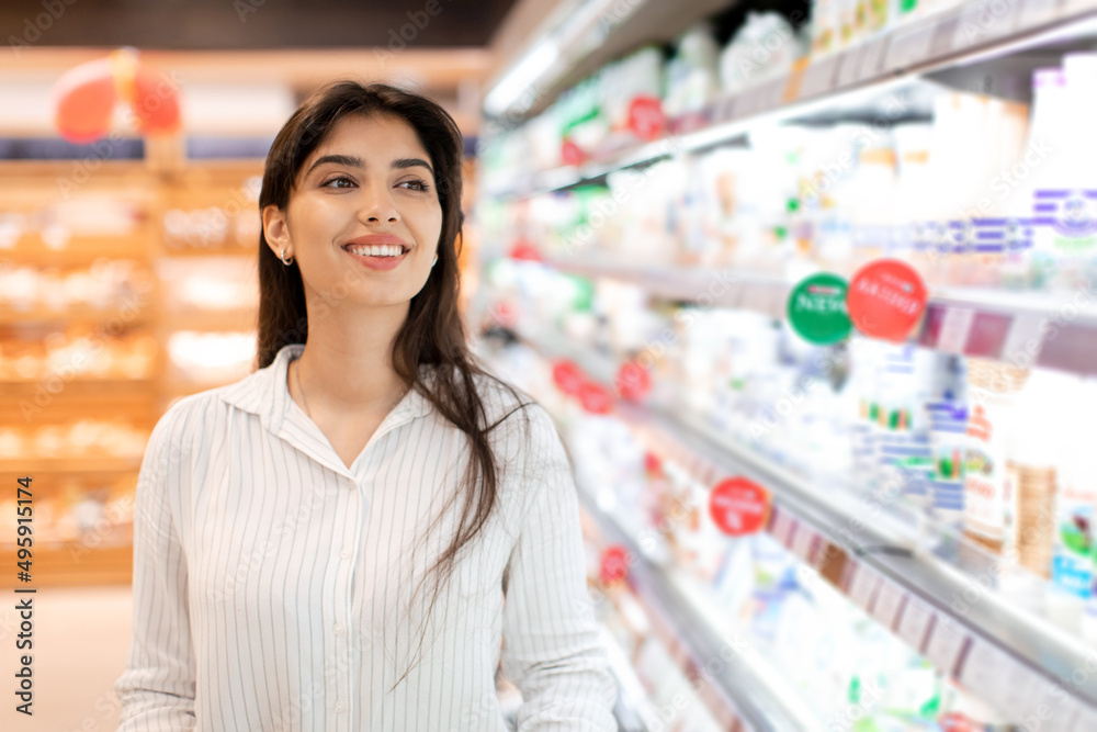 Portrait Of Happy Arabic Female Customer Standing In Supermarket