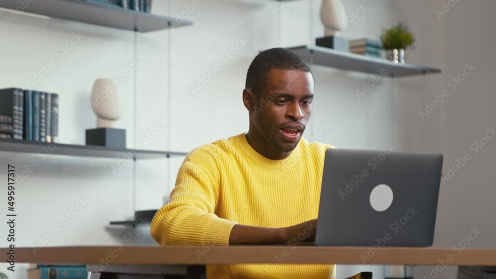 Young man typing on laptop keyboard at home office. Young african ethnic student studying Young man typing on laptop keyboard at home office. Young african ethnic student studying