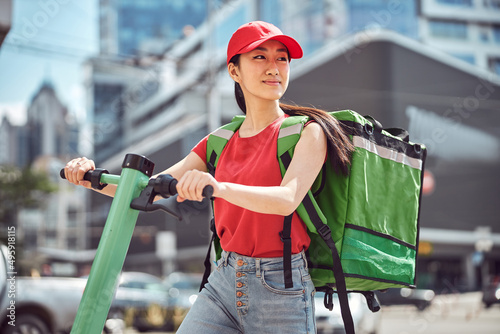 Young woman delivering food through city on sunny day