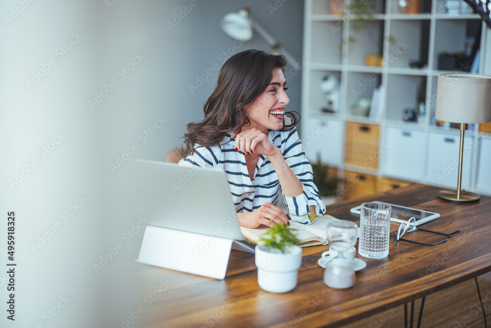 A beautiful business woman in casual clothes works on a virtual computer in the office desk. Small business owner people employed free online we are marketing e-commerce telemarketing A beautiful business woman in casual clothes works on a virtual computer in the office desk. Small business owner people employed free online we are marketing e-commerce telemarketing