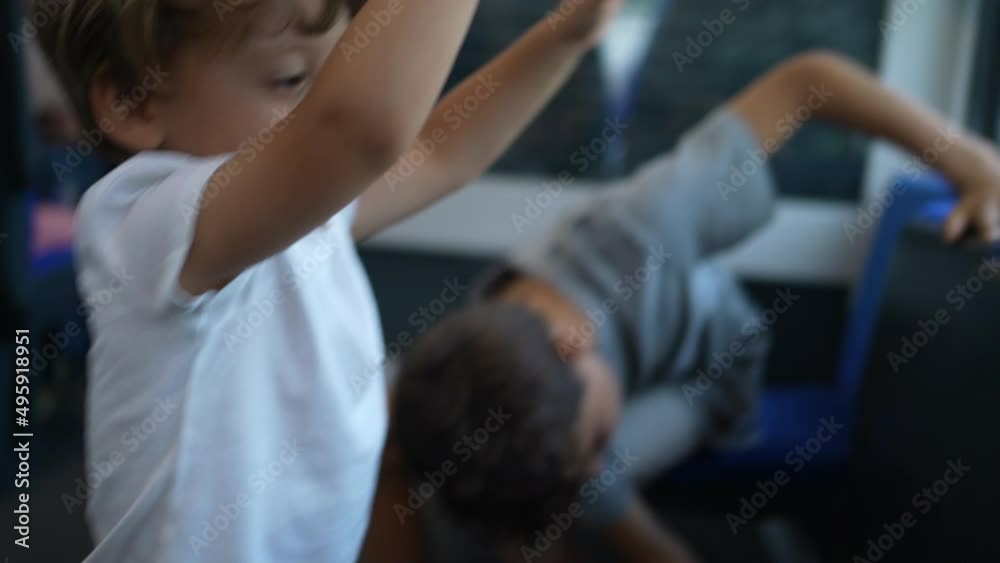 MIschievous children traveling by train kids not behaving playing with seats MIschievous children traveling by train kids not behaving playing with seats