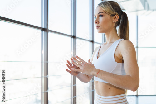 Close-up portrait of a athletic girl who is exercising indoors