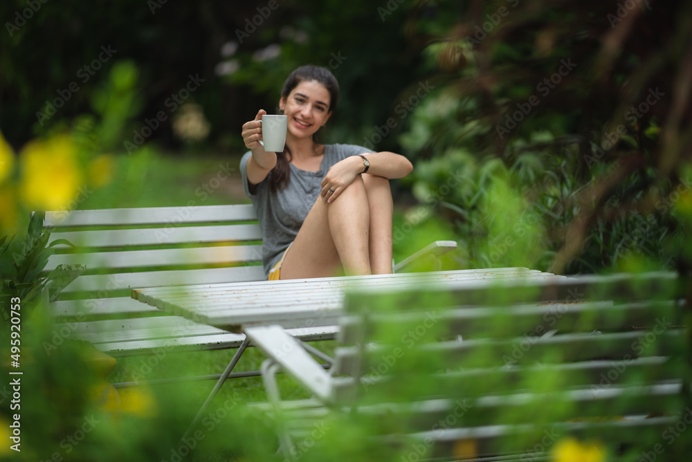 young beautiful woman person are happy and enjoy with coffee drink in the morning at home, relax lifestyle by holding coffee or tea cup at nature outdoor park, smile pretty girl with freedom time young beautiful woman person are happy and enjoy with coffee drink in the morning at home, relax lifestyle by holding coffee or tea cup at nature outdoor park, smile pretty girl with freedom time