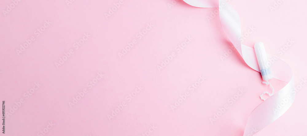 Menstrual tampon feminine hygiene. Pink ribbon with menstrual tampon on pink background. Menstruation feminine period. Sanitary hygiene concept. Medical healthcare gynecological banner.