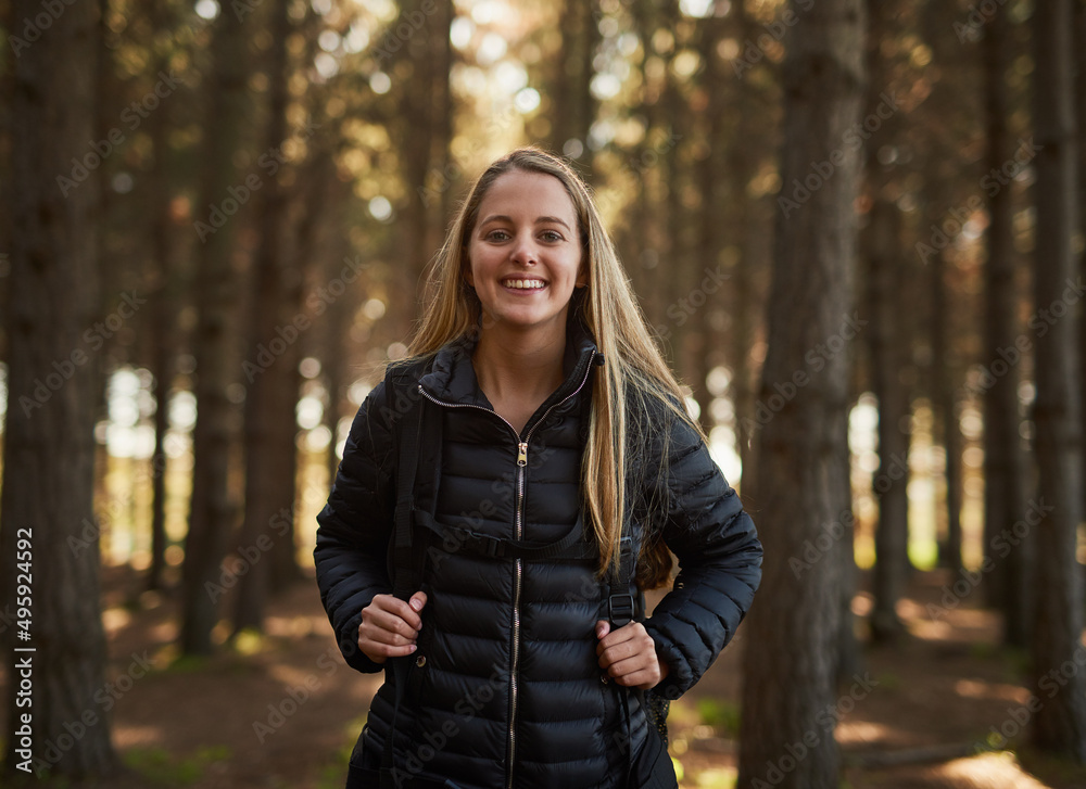 Setting off on an adventure. Portrait of a happy young woman exploring a forest on her own. Setting off on an adventure. Portrait of a happy young woman exploring a forest on her own.
