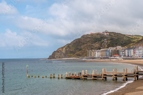 A view of the Aberystwyth Cliff Railway over sea front buildings and a small wooden jetty. Trams can be seen on the Constitution Hill track. photo