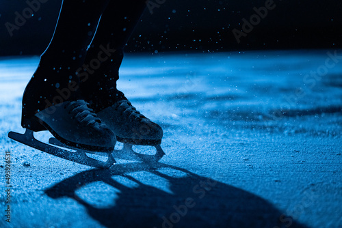 Bilde på lerret Legs of an athlete skater performing elements of a single female choreography on ice stadium