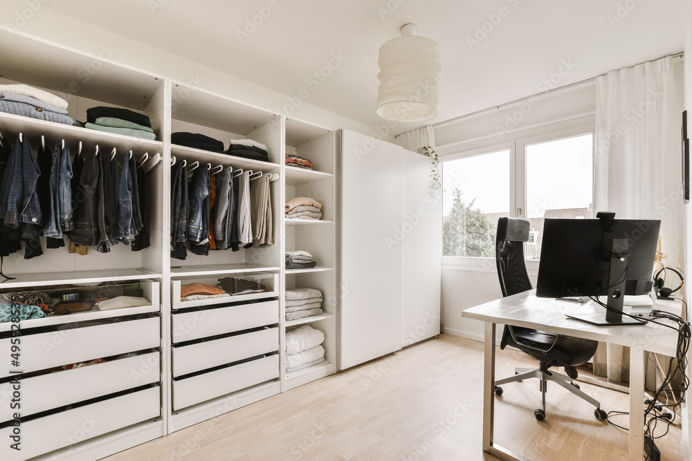 Interior of workroom with wardrobe and office table Stock Photo Adobe