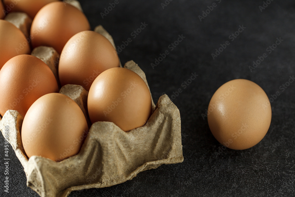 Chicken eggs, whole in cardboard tray, selective focus. Chicken eggs, whole in cardboard tray, selective focus.
