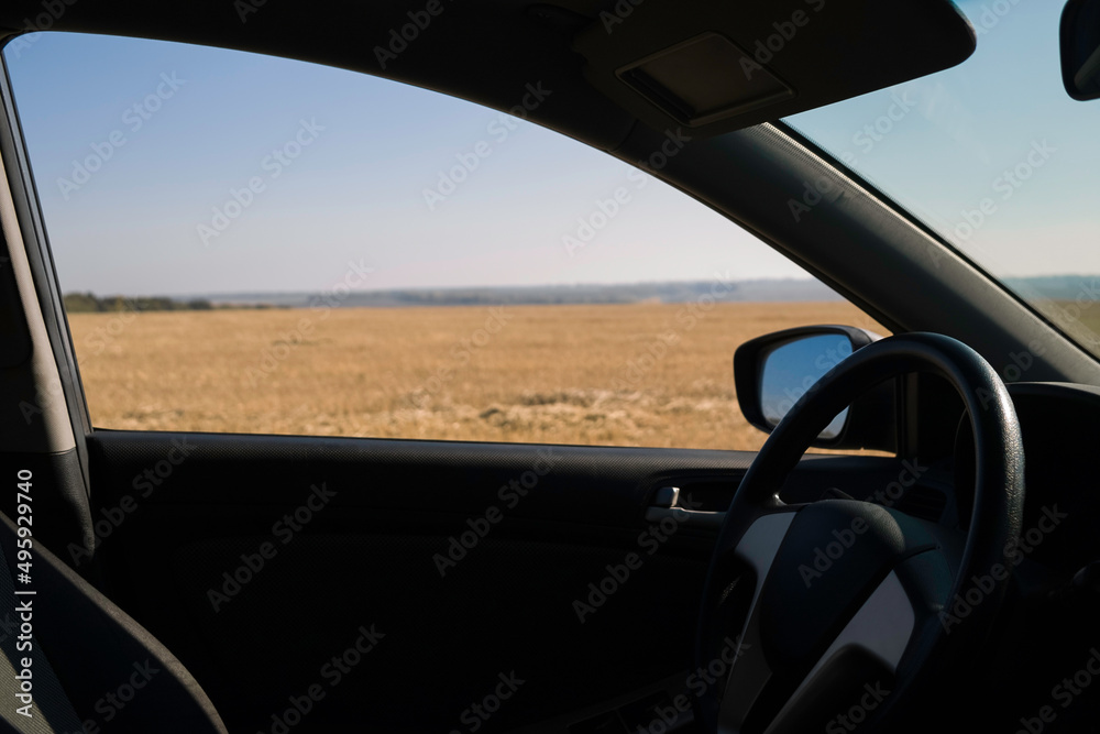 View from the car window on the autumn field on a sunny day View from the car window on the autumn field on a sunny day