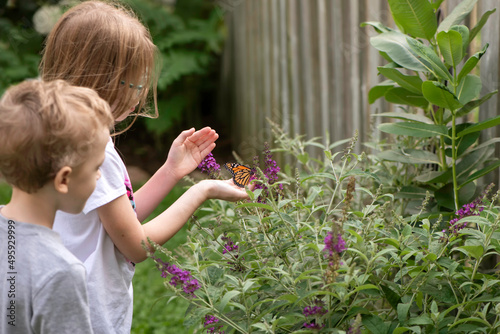child releasing monarch butterfly