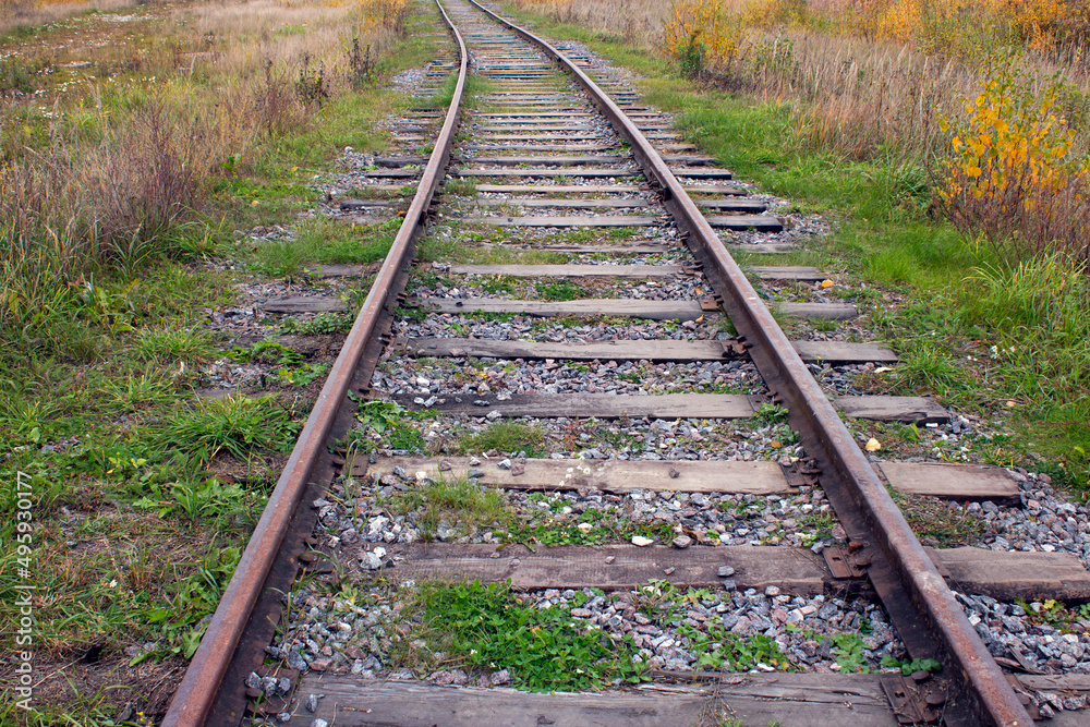A railway with rails and concrete sleepers.Background of an old rusty railway.Rails and sleepers on the railway. A railway with rails and concrete sleepers.Background of an old rusty railway.Rails and sleepers on the railway.
