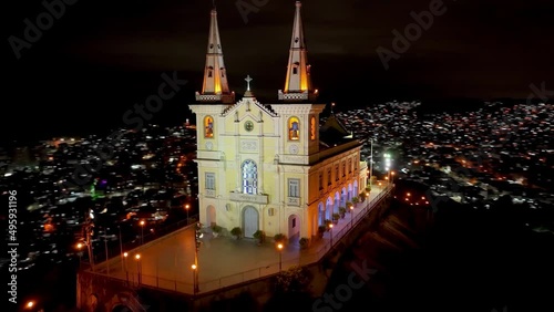 Night cityscape of Basilica of Penha at Rio de Janeiro Brazil. Medieval church. Panoramic view of illuminated church at peak of mountain at Rio de Janeiro Brazil near Alemao community. photo