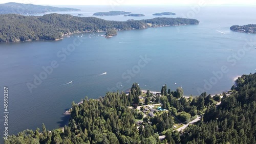 Beautiful ocean and coastline of Howe Sound near Soames Hill in Gibsons, Canada. Wide angle aerial tilt up shot photo