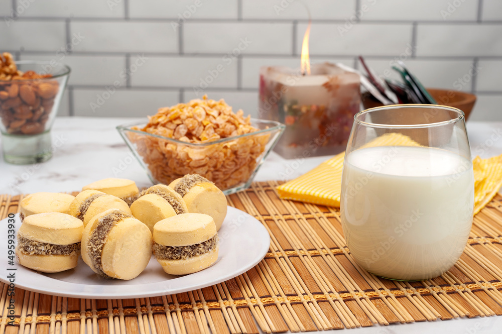 glass of milk with cornstarch alfajores nuts and cereals for a healthy breakfast or snack glass of milk with cornstarch alfajores nuts and cereals for a healthy breakfast or snack