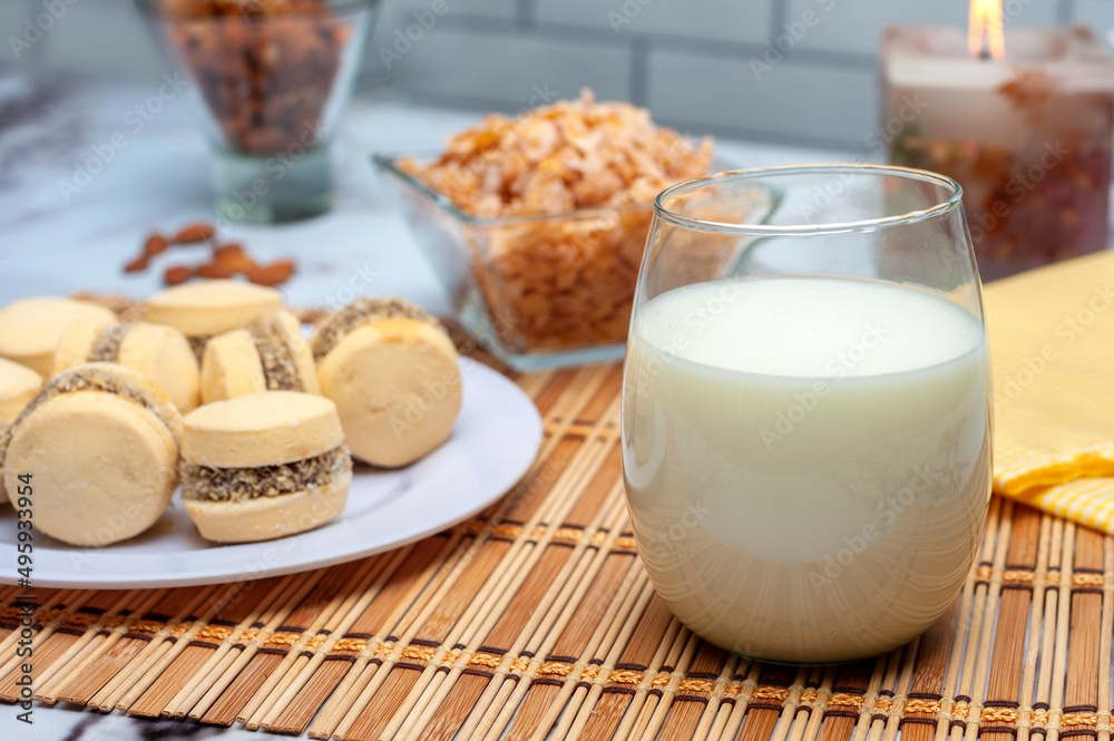 glass of milk with cornstarch alfajores nuts and cereals for a healthy breakfast or snack glass of milk with cornstarch alfajores nuts and cereals for a healthy breakfast or snack