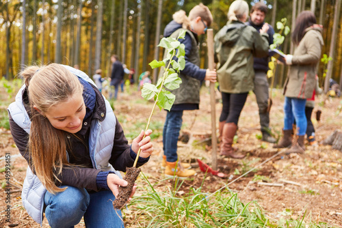 Girl with tree seedling as climate change tree