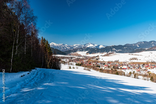 Liptovska Luzna village with hills around in Slovakia during beautiful winter day photo